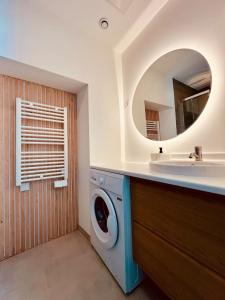 a bathroom with a washing machine and a sink at La Suite Balinaise - Home Homy in Saint-Florent-sur-Cher +31 photos