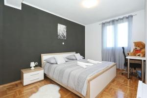 a bedroom with a bed with a teddy bear on it at Villa Solaris in Gradina +96 photos