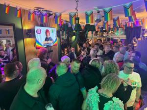 a group of people standing in a crowd at a party at McGraths Blackpool in Blackpool