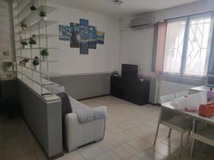 ein Wohnzimmer mit einem Stuhl und einem Tisch in der Unterkunft Two-room apartment in Voghera's historic center in Voghera + 12 Fotos