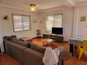 a living room with a couch and a table at Casita Central in Boquete