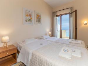a bedroom with two beds and a window at Sunset Hotel in Xiropigado