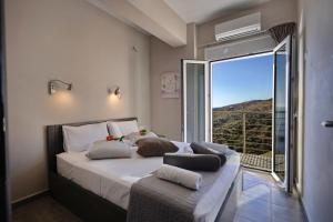 Posteľ alebo postele v izbe v ubytovaní Akrotiri Panorama- luxury rental apartments with sea view + 37 fotografií