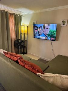a living room with a couch and a flat screen tv at Westview 4 in Saint James