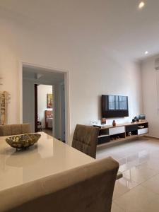 a living room with a table and a television at Refúgio Aconchegante em Botafogo in Rio de Janeiro
