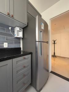 a kitchen with a stainless steel refrigerator in a kitchen at Refúgio Aconchegante em Botafogo in Rio de Janeiro