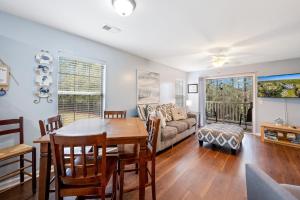 a living room with a table and a couch at 53C Tee to Sea condo in Pawleys Island