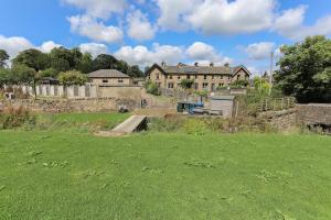 a large field with a large house in the background at Wend Gardens Studio Carleton Skipton Pet Friendly in Skipton