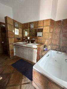 a large bathroom with a tub and a sink at Villa Loupiro in Mijas +18 photos