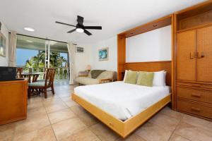 a bedroom with a bed and a living room at Kona Islander Inn#309 in Kailua-Kona