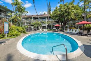 a swimming pool in front of a hotel at Kona Islander Inn#309 in Kailua-Kona