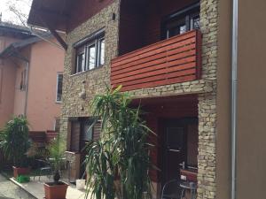 a house with a wooden deck on the side of it at New Beachapartman in Siófok
