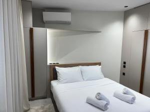 a bedroom with a bed with two towels on it at POST VIEW Center Luxury Apartments 5 in Ioannina