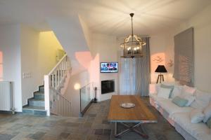 a living room with a couch and a table at PyleanBlue villas in Pylos