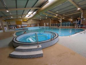 a large swimming pool in a large building at Big Boss Caravan-Camber Sands,Sleep 8, Free Wi-Fi, Netflix, Parking in Camber