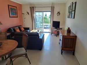 a living room with a couch and a table at Sunset Apartment in Porches