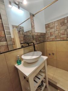 a bathroom with a sink and a mirror at Aisha Alojamiento in Salta
