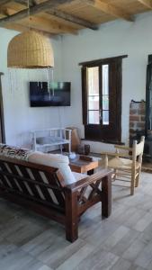a living room with a couch and a table at Casa De Campo El Corral in Carmen de Areco +56 photos