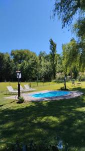 a swimming pool in the middle of a park at Casa De Campo El Corral in Carmen de Areco