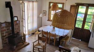 a living room with a table and a fireplace at Casa De Campo El Corral in Carmen de Areco
