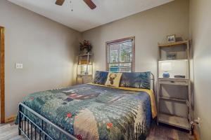 a bedroom with a bed and a window at Sanctuary in Pigeon Forge