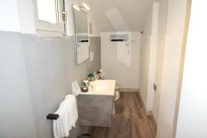 a white bathroom with a sink and a mirror at B&B il Rio in Anacapri +28 photos
