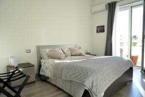 a bedroom with a bed and a large window at B&B il Rio in Anacapri