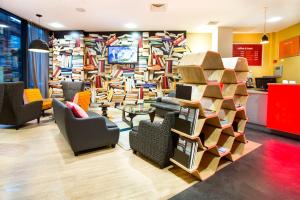 a lobby with a large wall of books at Sleeperz Hotel Newcastle in Newcastle upon Tyne