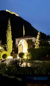 a church in front of a mountain at night at SokratesVilla in Mystras