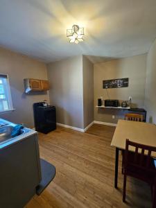 an empty living room with a table and a kitchen at Spacious one bedroom apartment near Whole Foods, Brown University 22F in Providence +6 photos