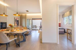a living room and dining room with a table and chairs at Olive Garden House in Gastouri