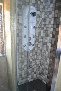 a shower with a glass door in a bathroom at Casa da Eduardinha in Góis