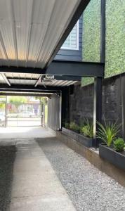 a walkway leading into a building with plants at Departamentos Santa Bárbara Osorno in Osorno