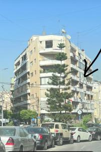 a tall building with cars parked in front of it at Byout Beirut G3 in Beirut