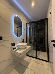 a bathroom with a sink and a glass shower at Panorama Hotel - Restaurant in Diakopto +114 photos
