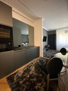 a hotel room with a bed and a kitchen at LY Studio Pipera in Voluntari