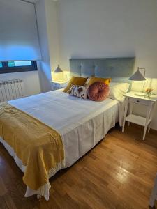 a bedroom with a large bed and a table at Casa Entre Viñas, jardin privado con piscina comunitaria in Uruñuela +36 photos