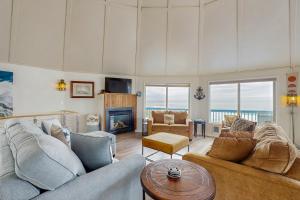 a living room with two couches and a fireplace at Waive Time in Lincoln City