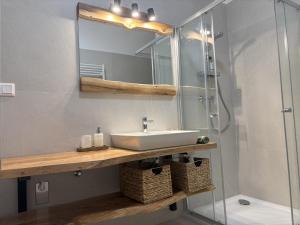 a bathroom with a sink and a shower at Apartman SPORKA in Púchov