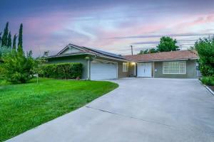 a house with a driveway and a garage at Modern Oasis for Families & Business, Pets OK, EV in Orange