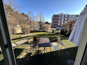 a patio with a table and chairs and a building at Apartment near trade fair, rhine and city in Cologne