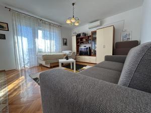 a living room with a couch and a table at Azure Apartments By The Sea Near City Omiš in Omiš