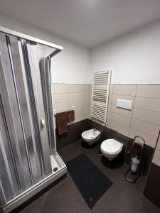 a bathroom with a shower and a toilet and a sink at Casa Camelia in Zagarolo