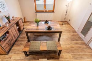 a living room with a table and a bench at Ferienwohnung Eifelhöhe Pützer in Hellenthal
