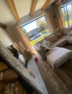 ミコワイキにあるVilla Hamptonsのソファと大きな窓のあるリビングルーム +15枚の写真