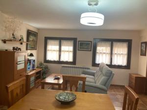 a living room with a couch and a table at Apartamento O'royo in Alquézar