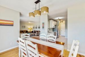 a dining room and living room with a table and chairs at Fairway Watch - 295 in Edisto Beach