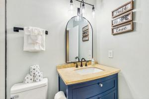 a bathroom with a sink and a mirror at Fairway Watch - 295 in Edisto Beach +12 photos