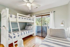 a bedroom with two bunk beds and a ceiling fan at Fairway Watch - 295 in Edisto Beach