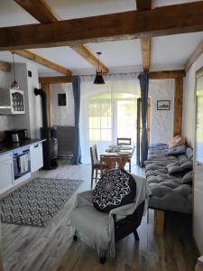 a living room with a bed and a table at Barn - Nocleg na Mazurach in Sołtmany